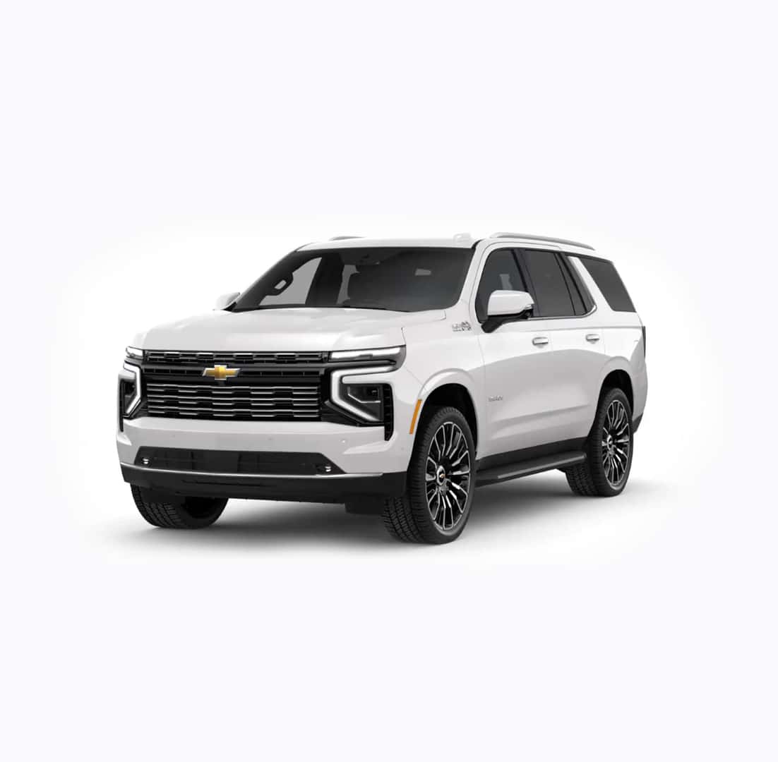 A white SUV with a sleek design, featuring black accents, a prominent front grille with a gold emblem, and modern headlights. The vehicle is parked on a plain white background.