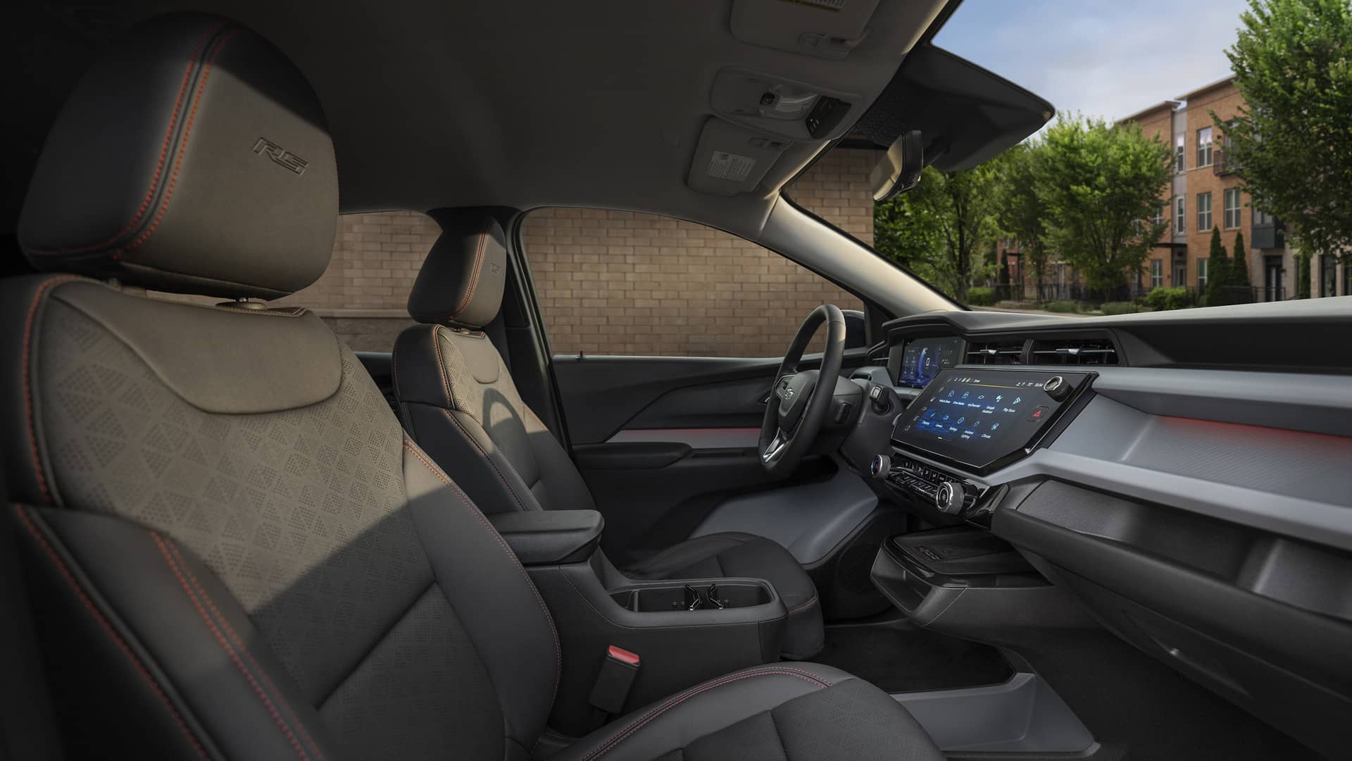 Modern car interior with sleek dashboard, touchscreen display, and detailed seat stitching.